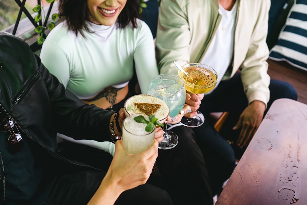 a group of people holding up wine glasses