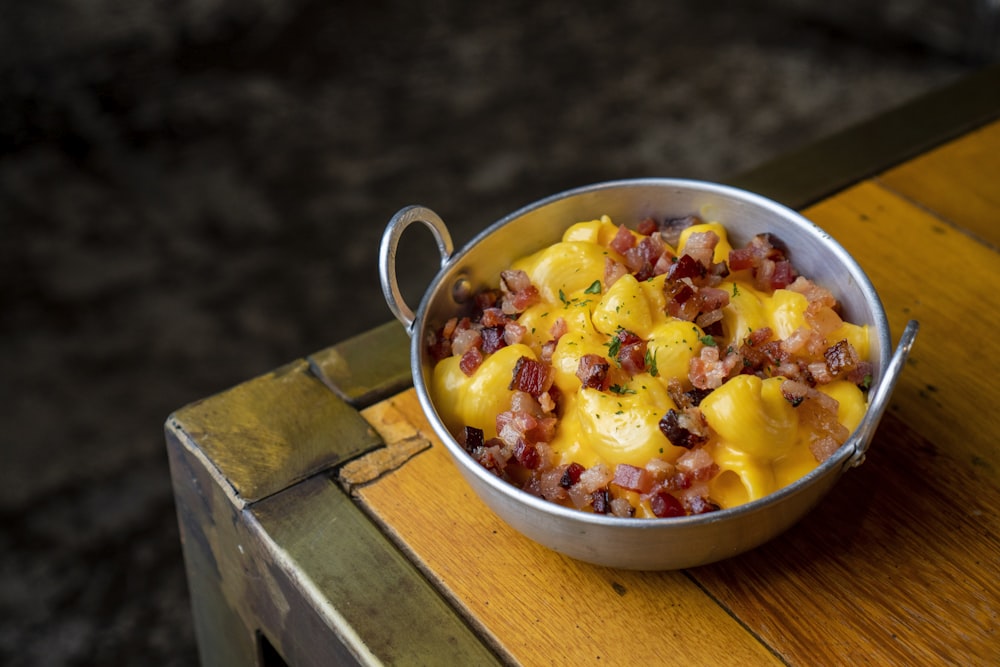 a bowl of food sitting on top of a wooden table