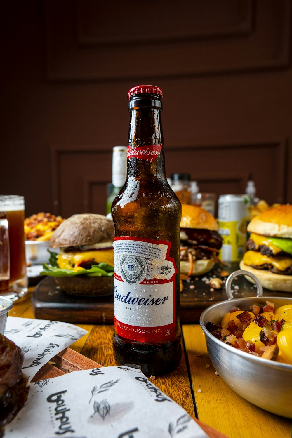 a bottle of beer sitting on top of a wooden table