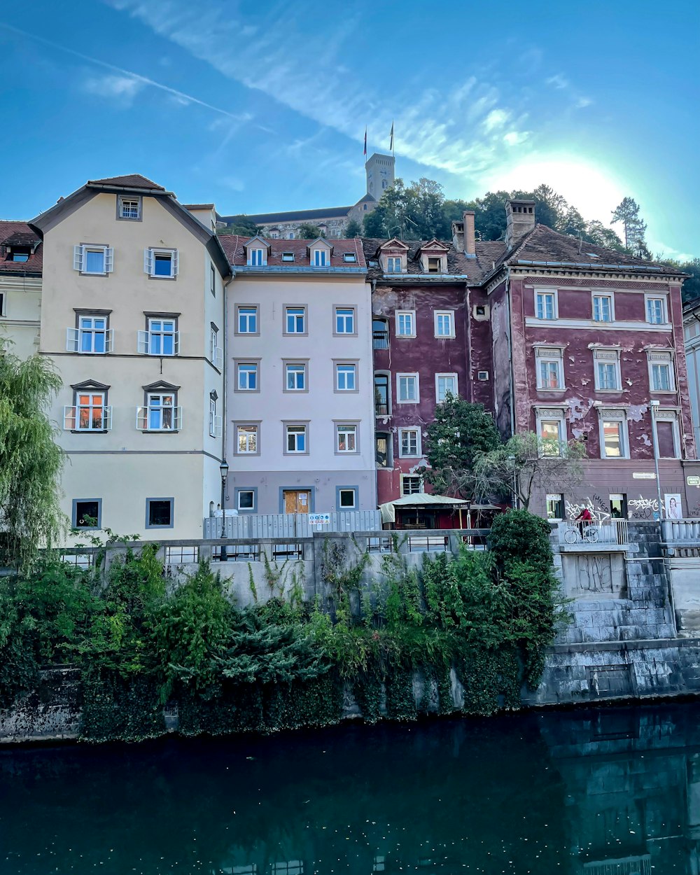 a row of buildings next to a body of water