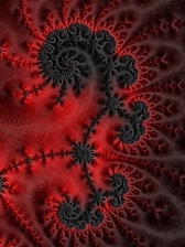 a computer generated image of red and black swirls