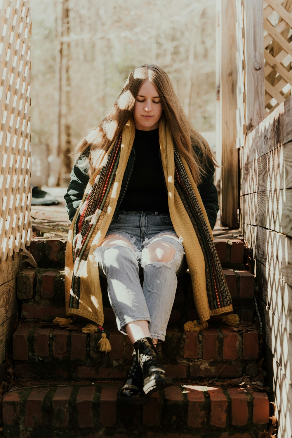 a woman sitting on the steps of a house