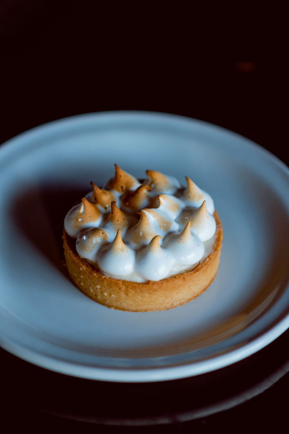 a small pastry on a white plate on a table