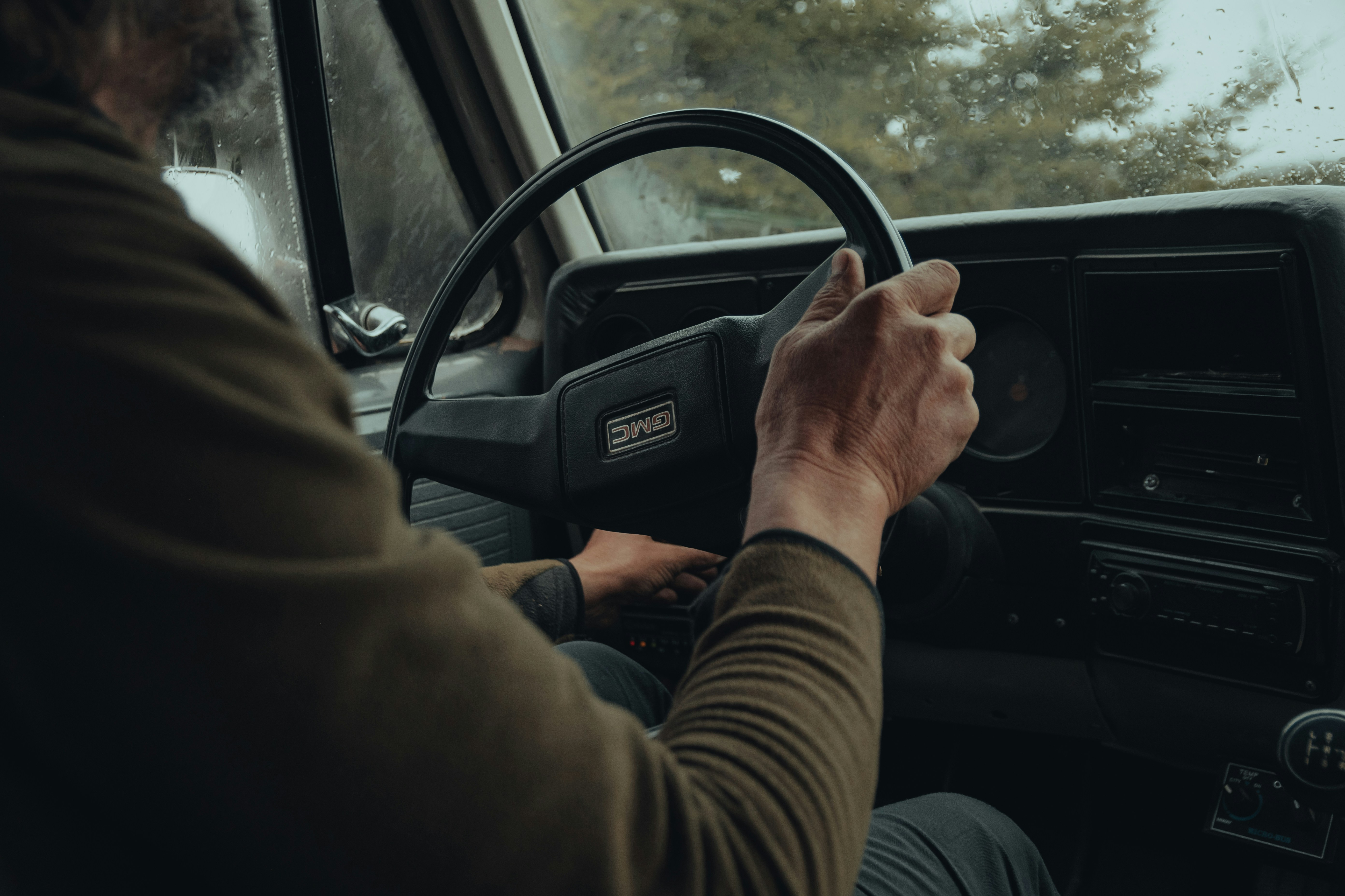 truck driver's hands on a steering wheel - Average truck insurance cost