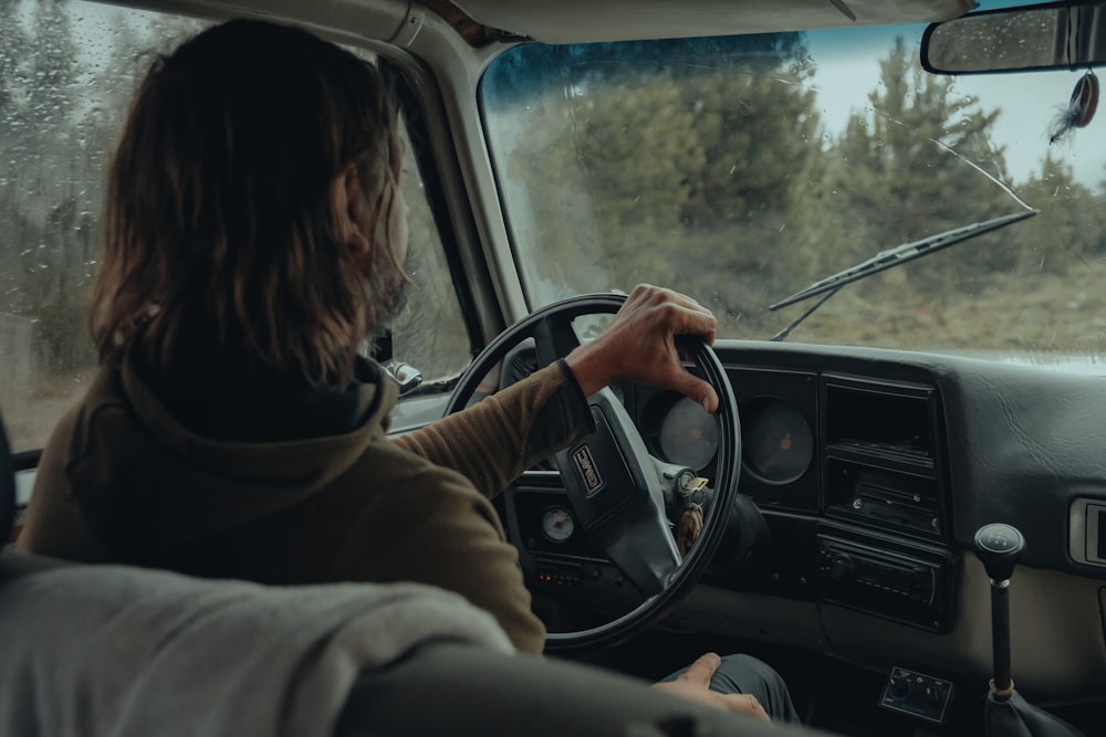 a woman driving a truck in the rain