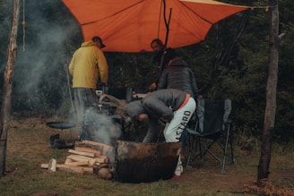 a group of people sitting around a fire pit
