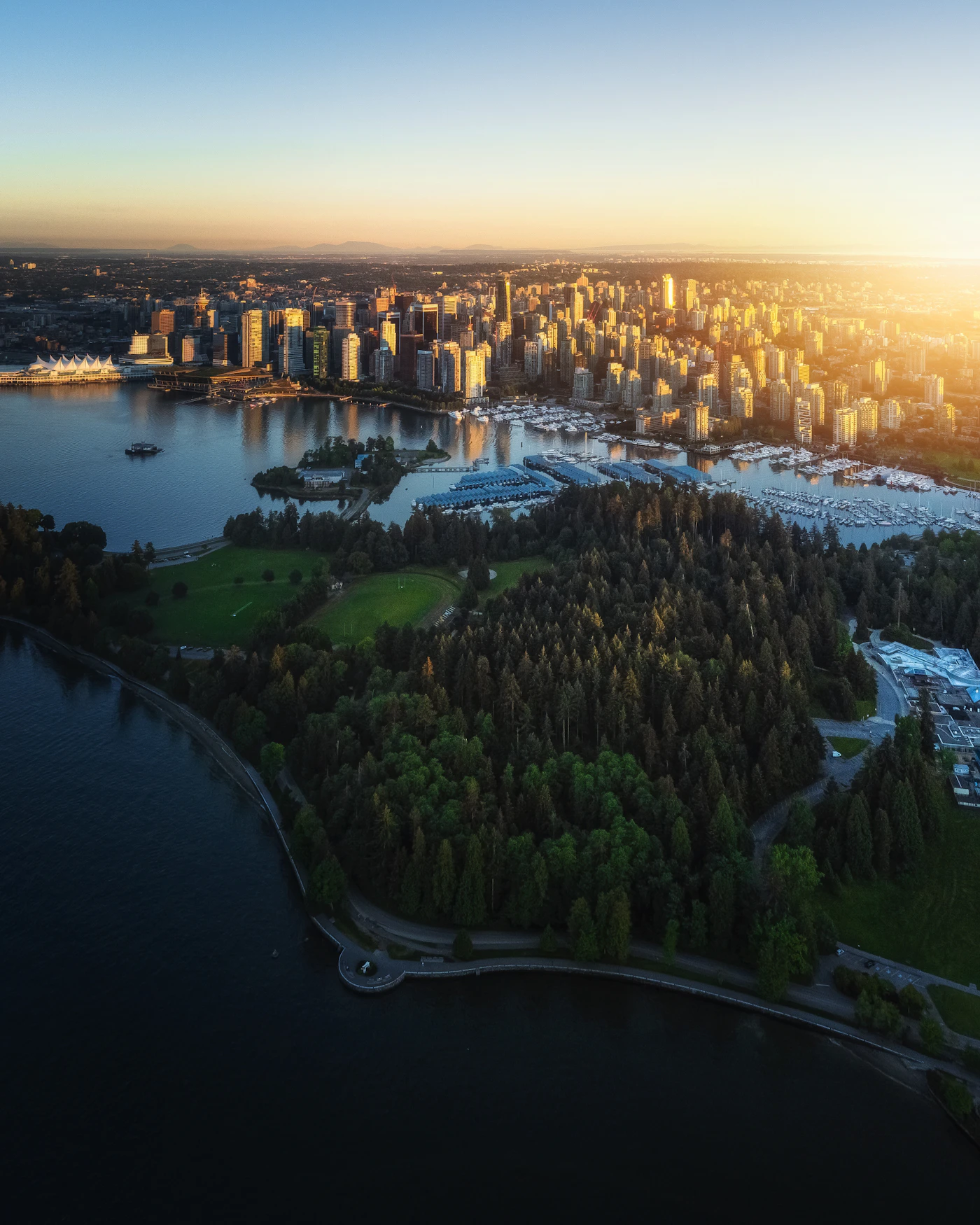 Aerial view of a coastal British Columbia city beside the water at golden hour