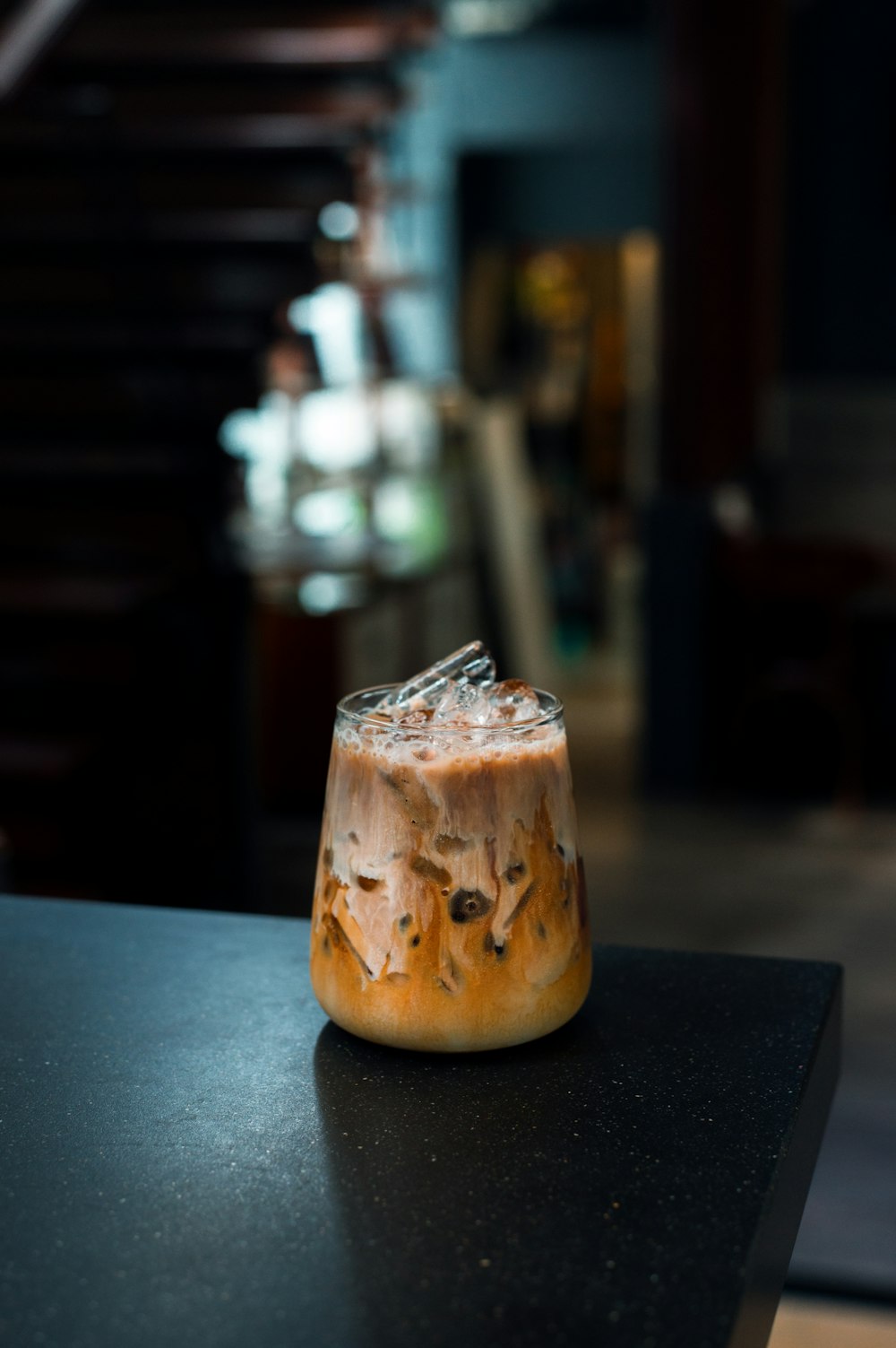 a drink sitting on top of a black table