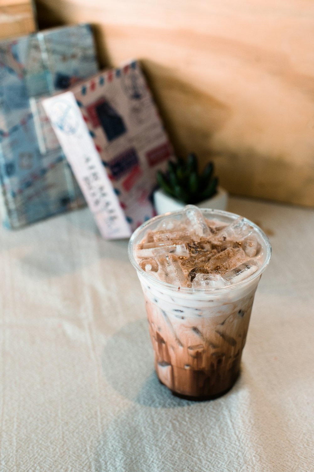 a cup of iced coffee sitting on top of a table