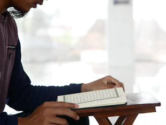 A serene workspace showing a person reading theological texts with notes.