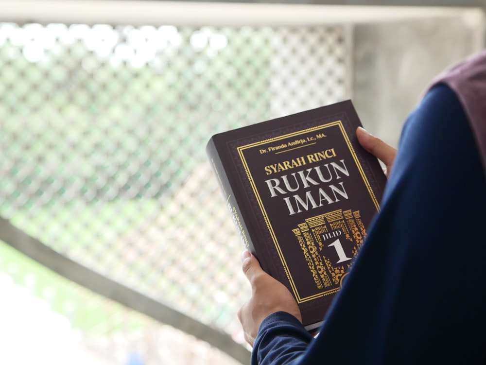 a person holding a book in their hands