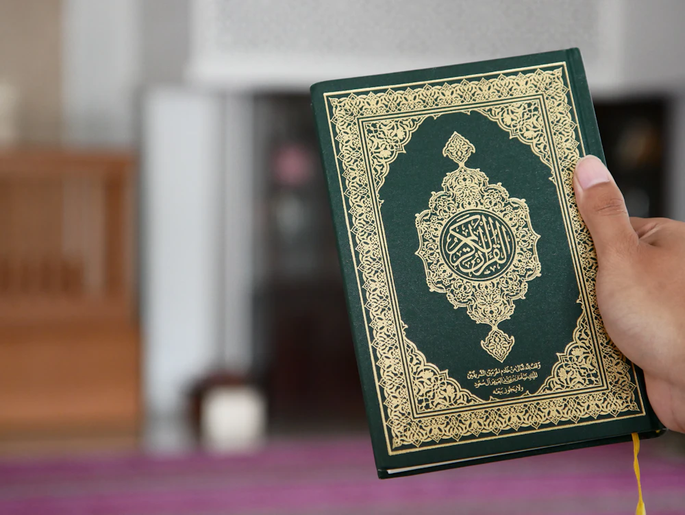 A student's copy of the Quran open for a Tajweed lesson