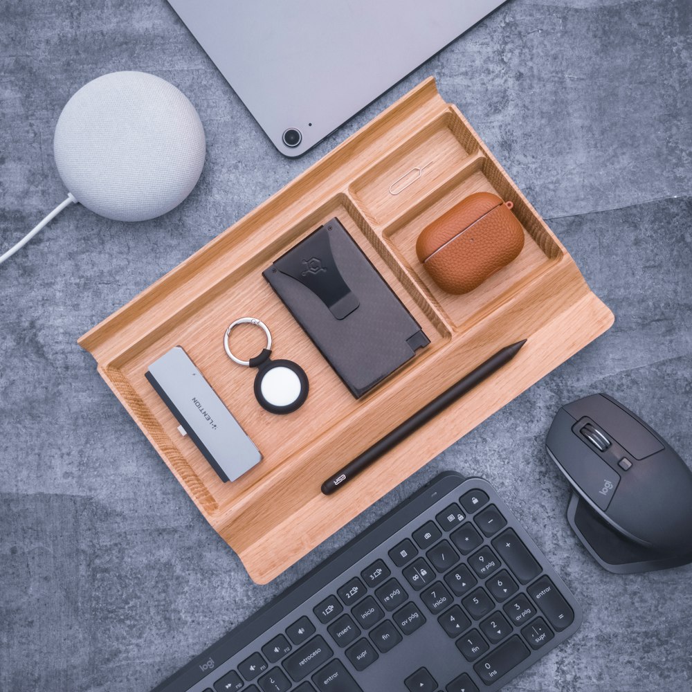 a desk with a keyboard, mouse, and other items