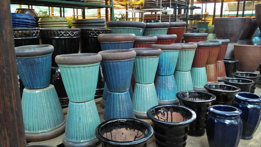 a bunch of vases that are sitting on the ground