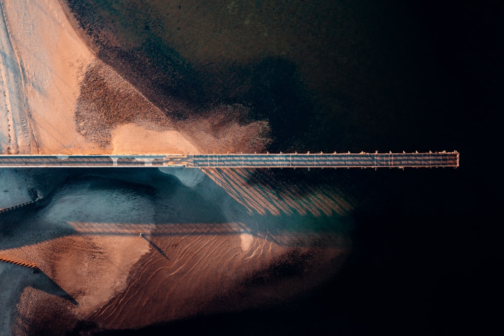 an aerial view of a bridge over a body of water