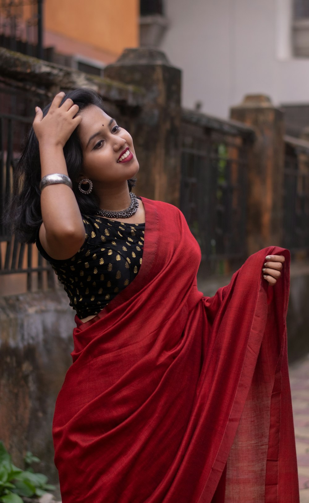 A woman in a red sari posing for the camera photo Free West bengal Image on Unsplash