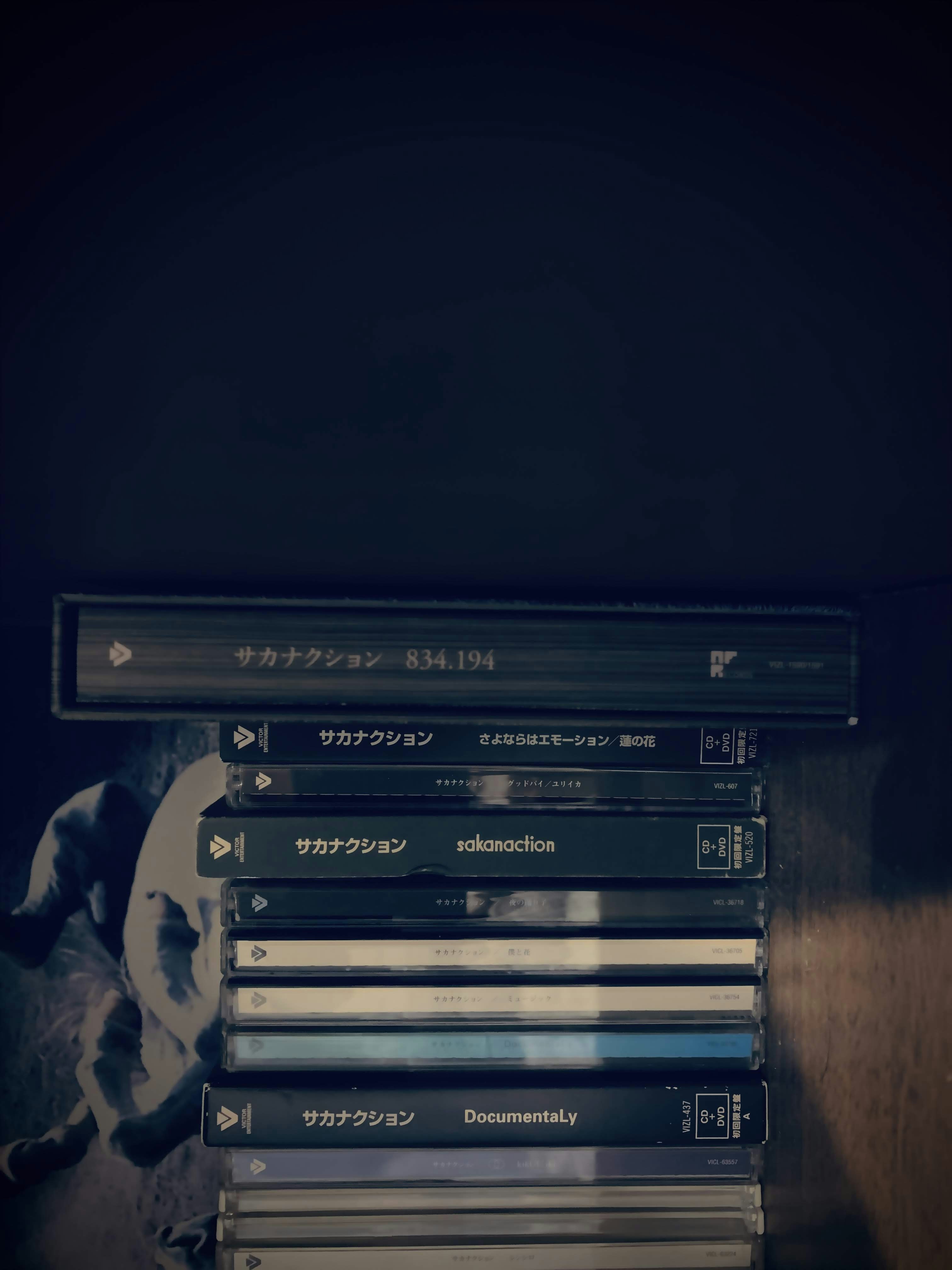 A stack of dvds sitting on top of a wooden table photo – Free Grey ...