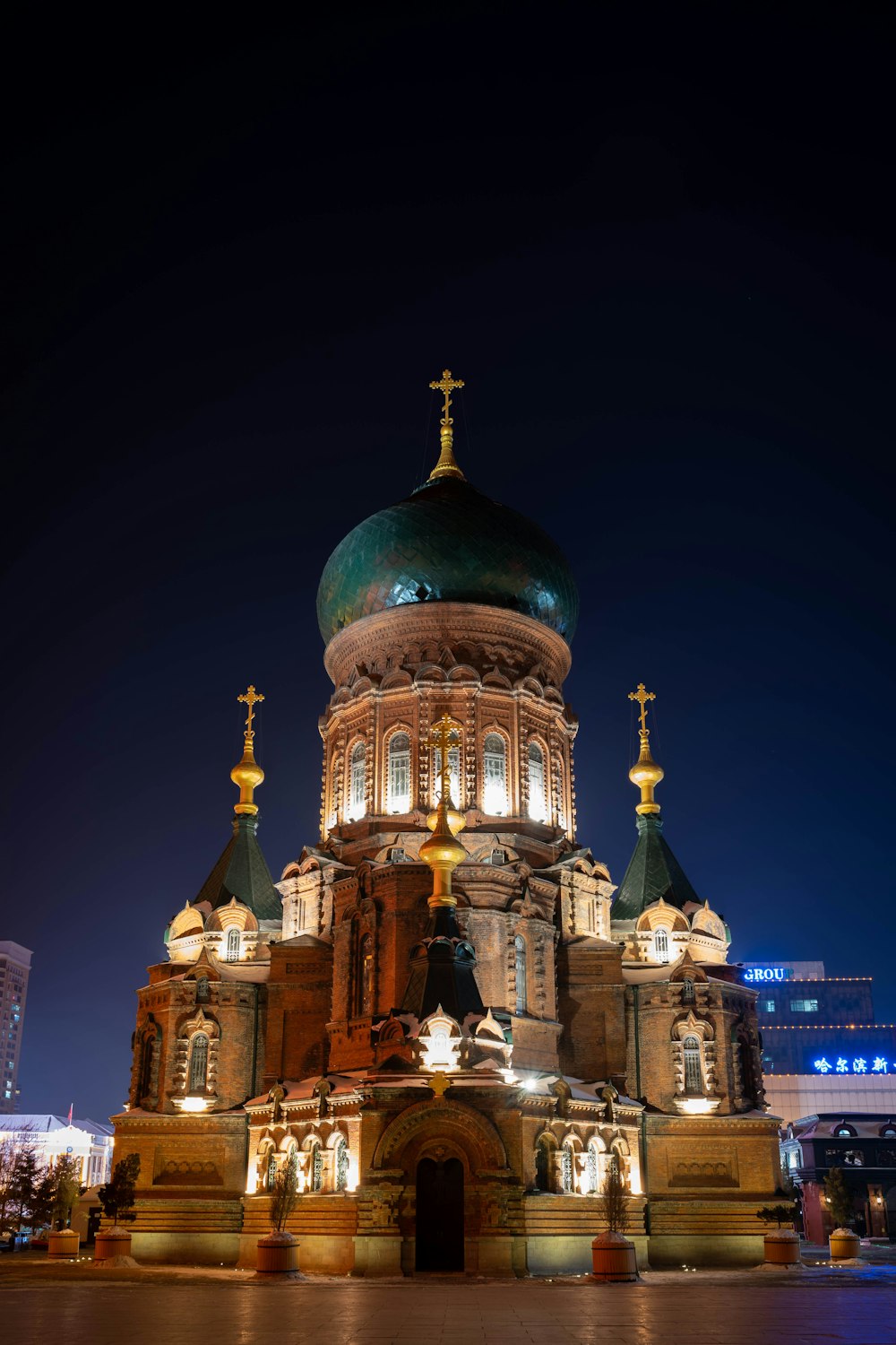 a large building with a green dome at night