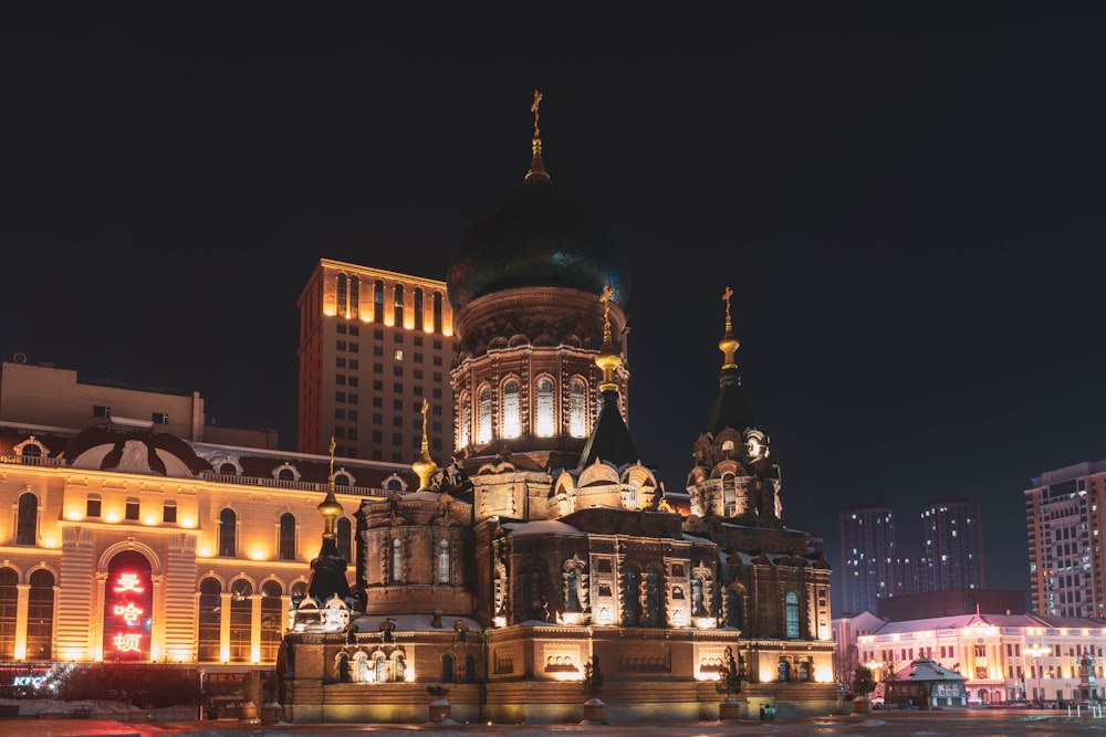 a building lit up at night in a city