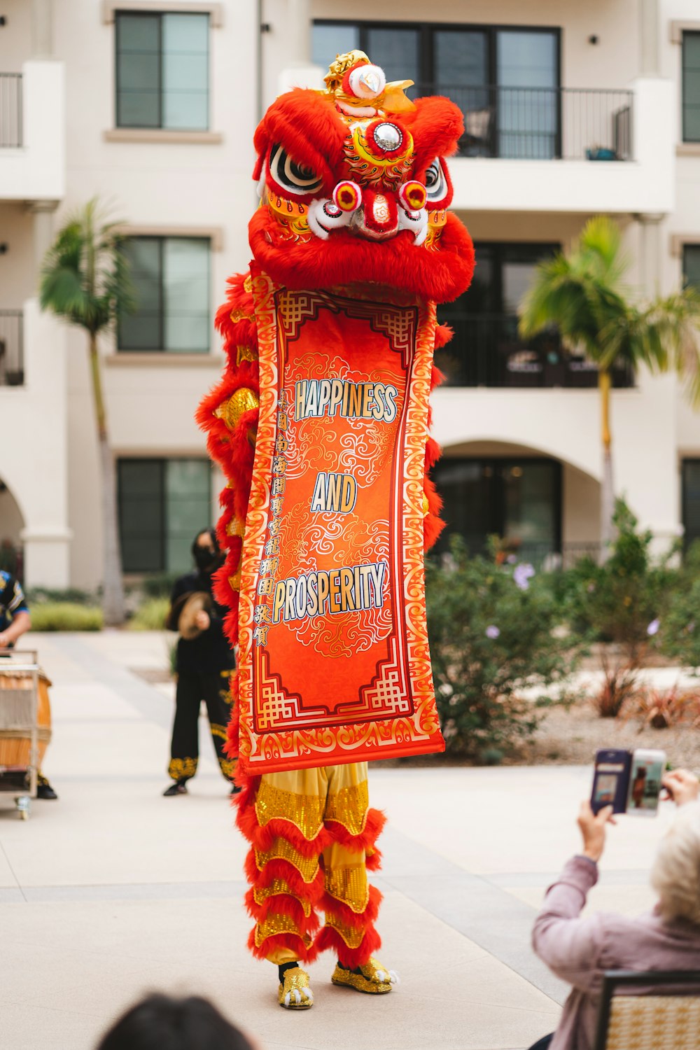 a man in a dragon costume holding a cell phone