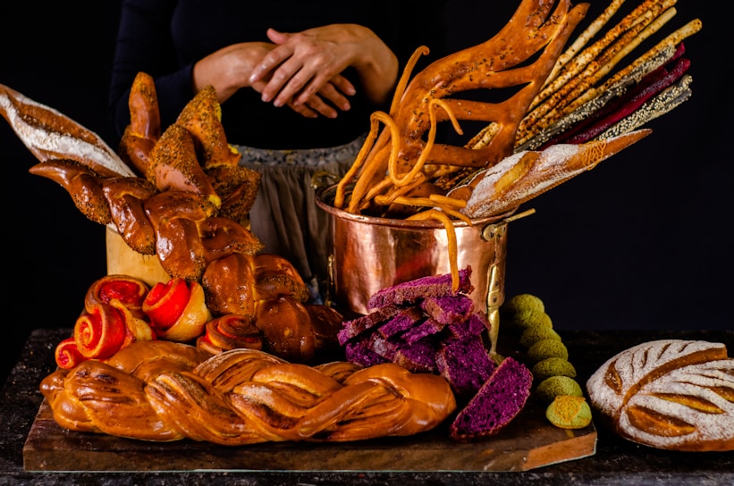 A vibrant purple-themed website homepage designed for a local artisan bakery, showcasing warm, inviting visuals.