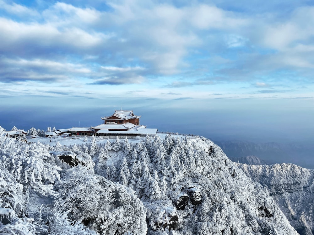 a snow covered mountain with a building on top of it