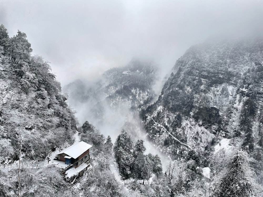 a cabin in the mountains covered in snow