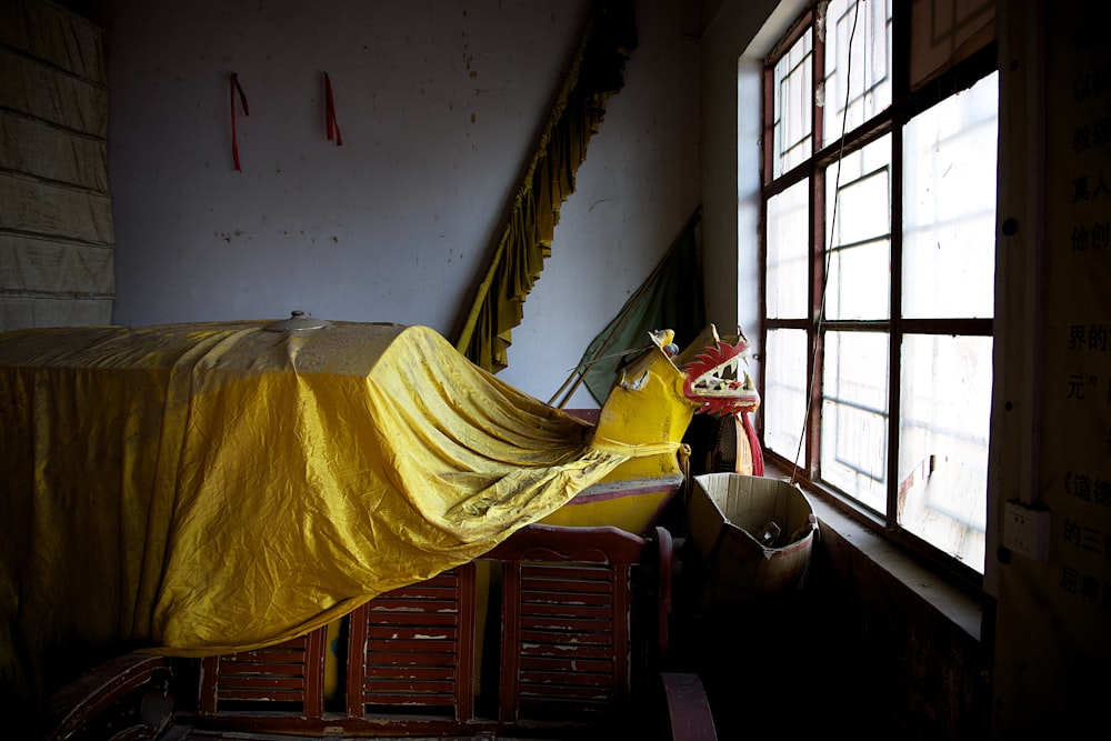 a bed sitting next to a window in a room