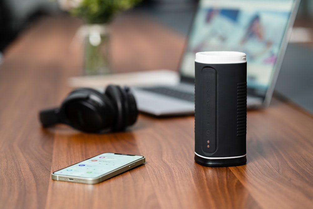 a cell phone sitting on a table next to a speaker