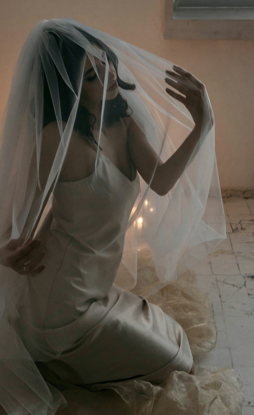 a woman wearing a veil sitting on a bed