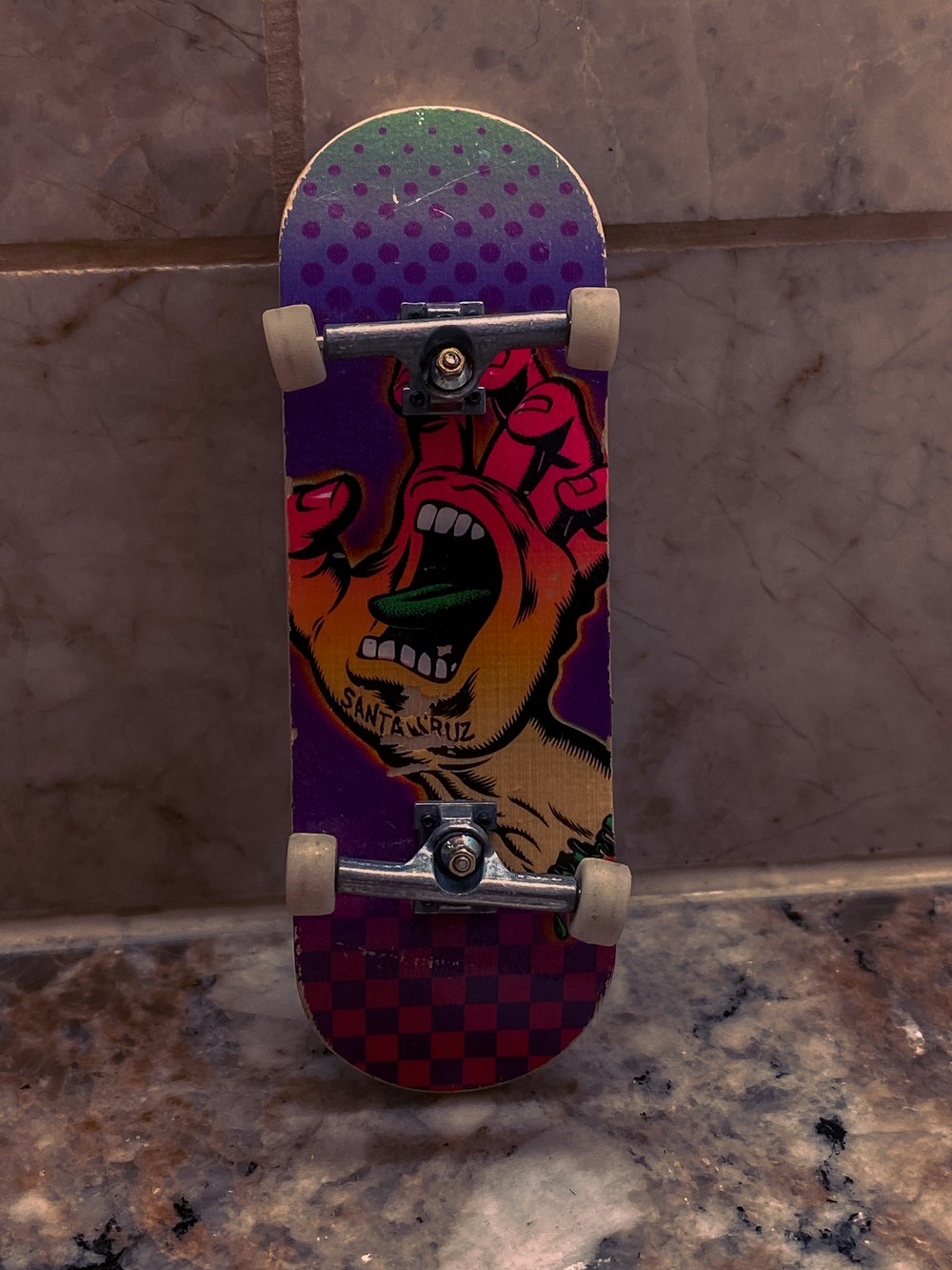 a skateboard with a picture of a screaming hand on it