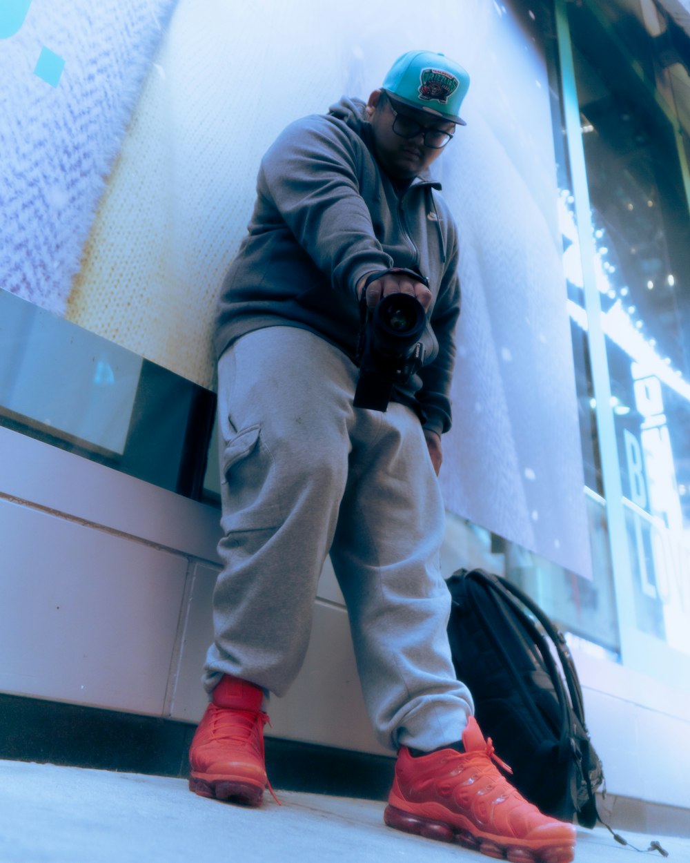 a man sitting on a wall next to a bag of luggage