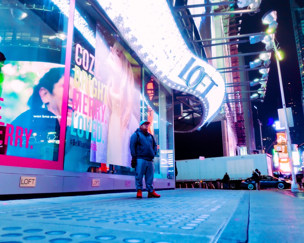 a man standing in front of a building at night