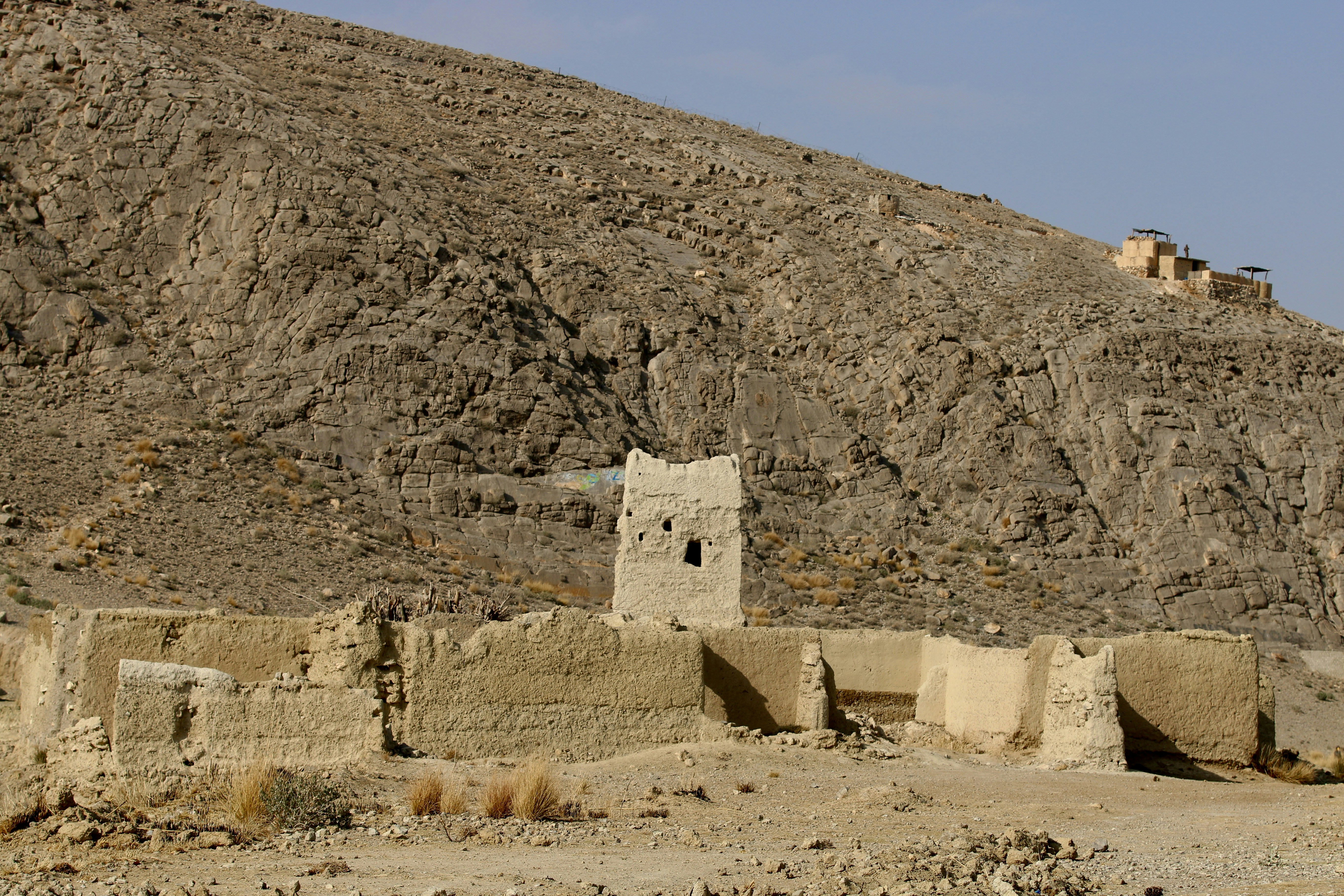 a stone building in the middle of a desert