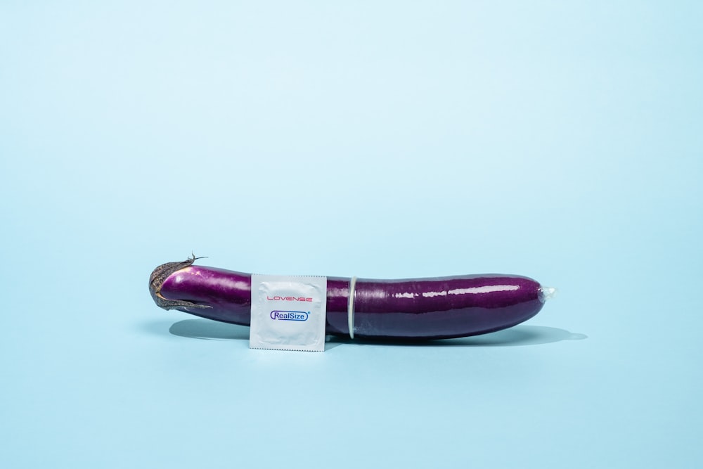 a purple eggplant with a sticker on it