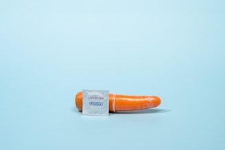 a single carrot wrapped in a plastic bag