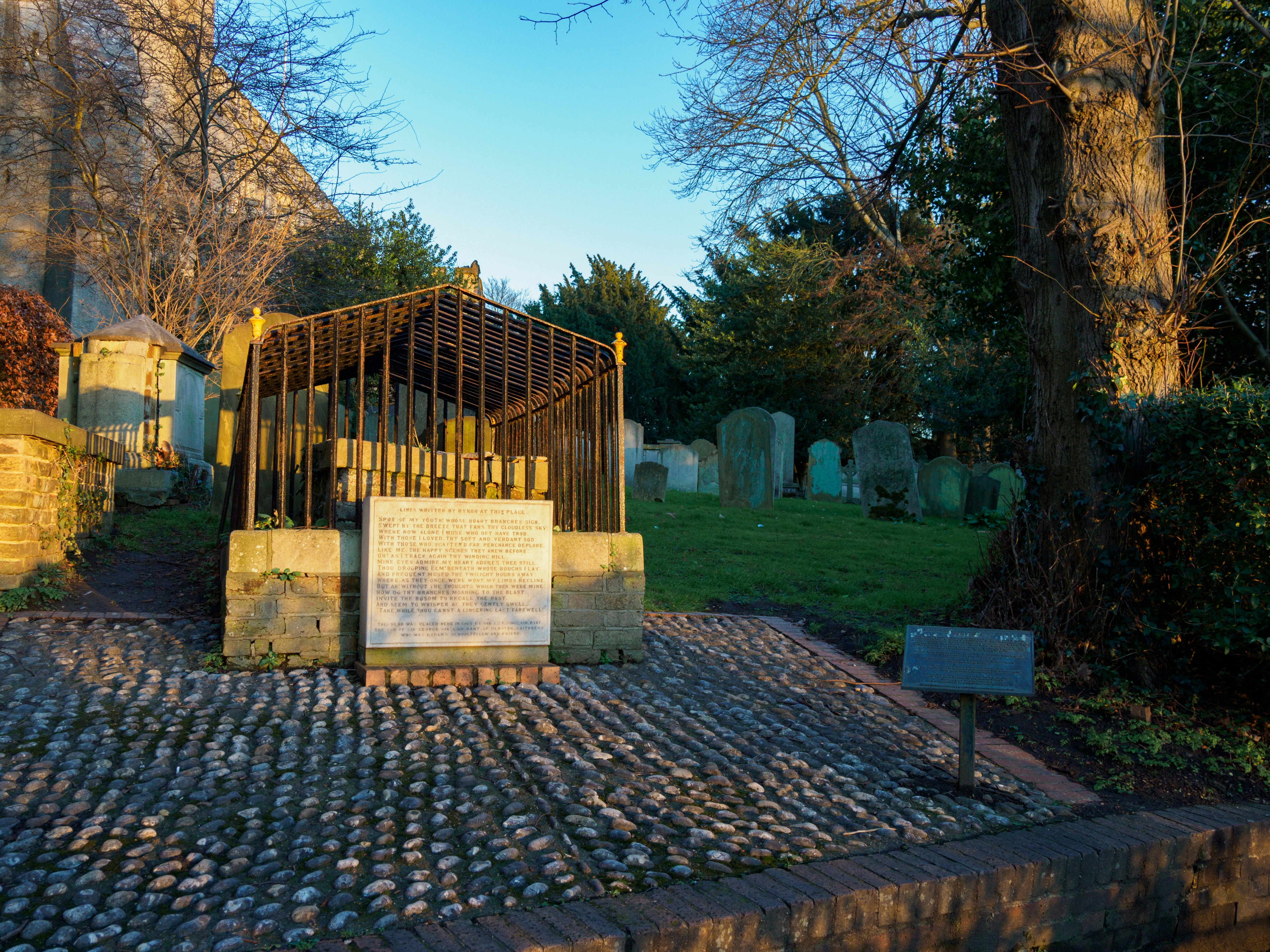 a cemetery with a small structure in the middle of it