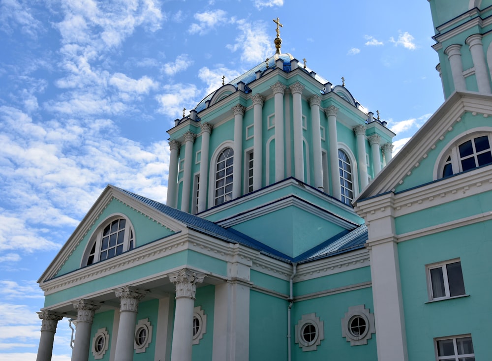 a blue and white building with a blue roof