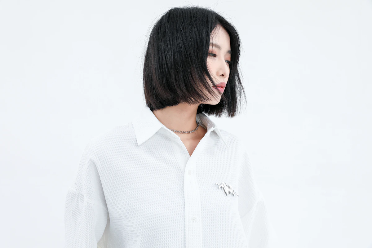 A woman in a minimalist white shirt — the reinvented wardrobe staple