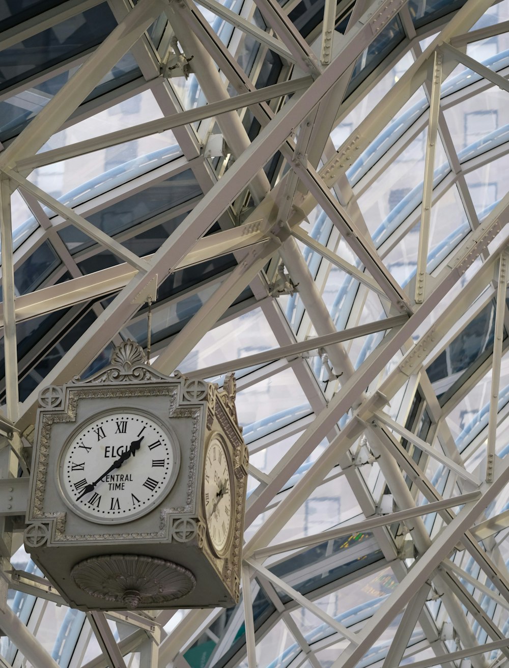 a clock hanging from the ceiling of a building