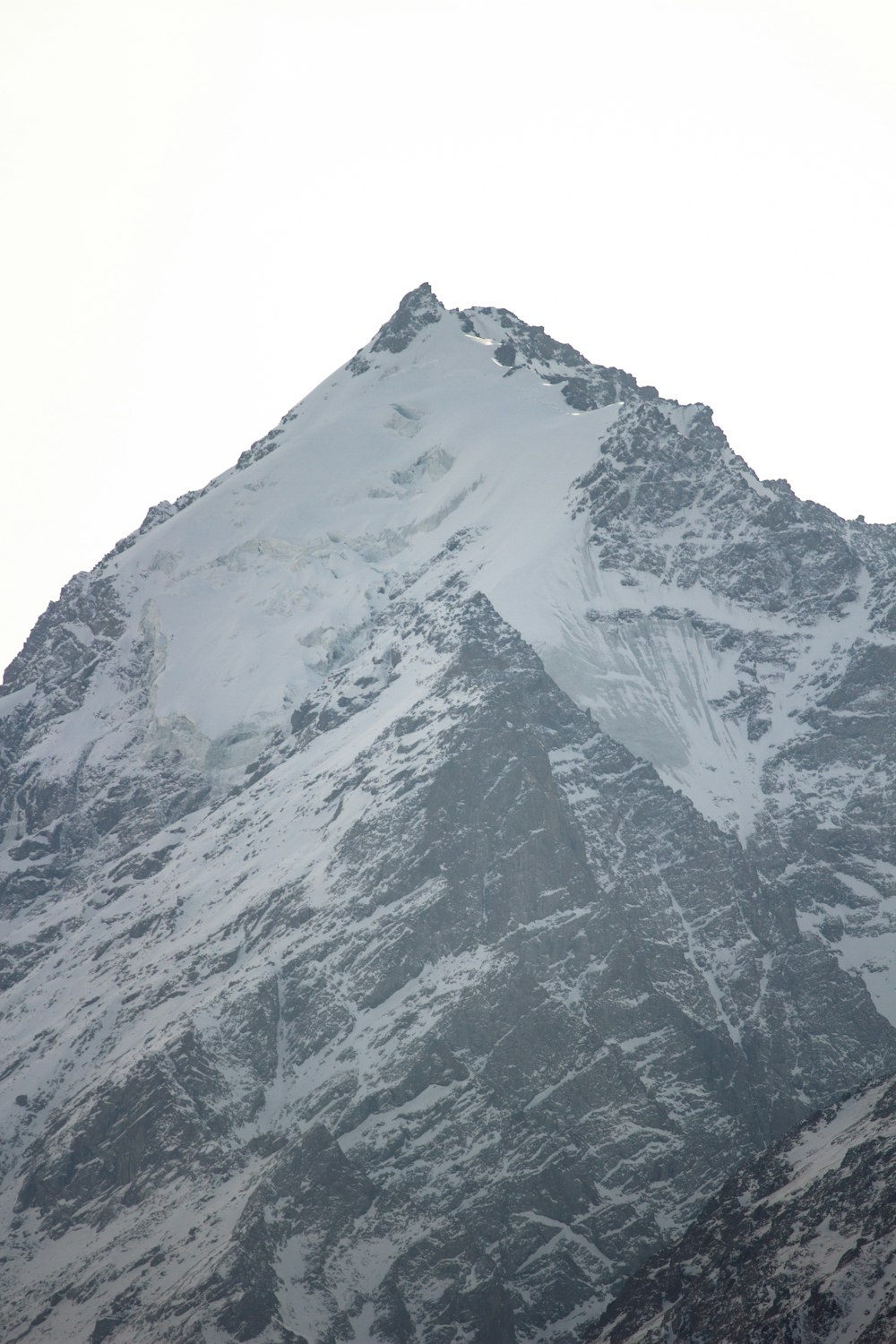 a large snow covered mountain with a sky background