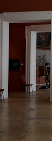 a living room with red walls and white columns