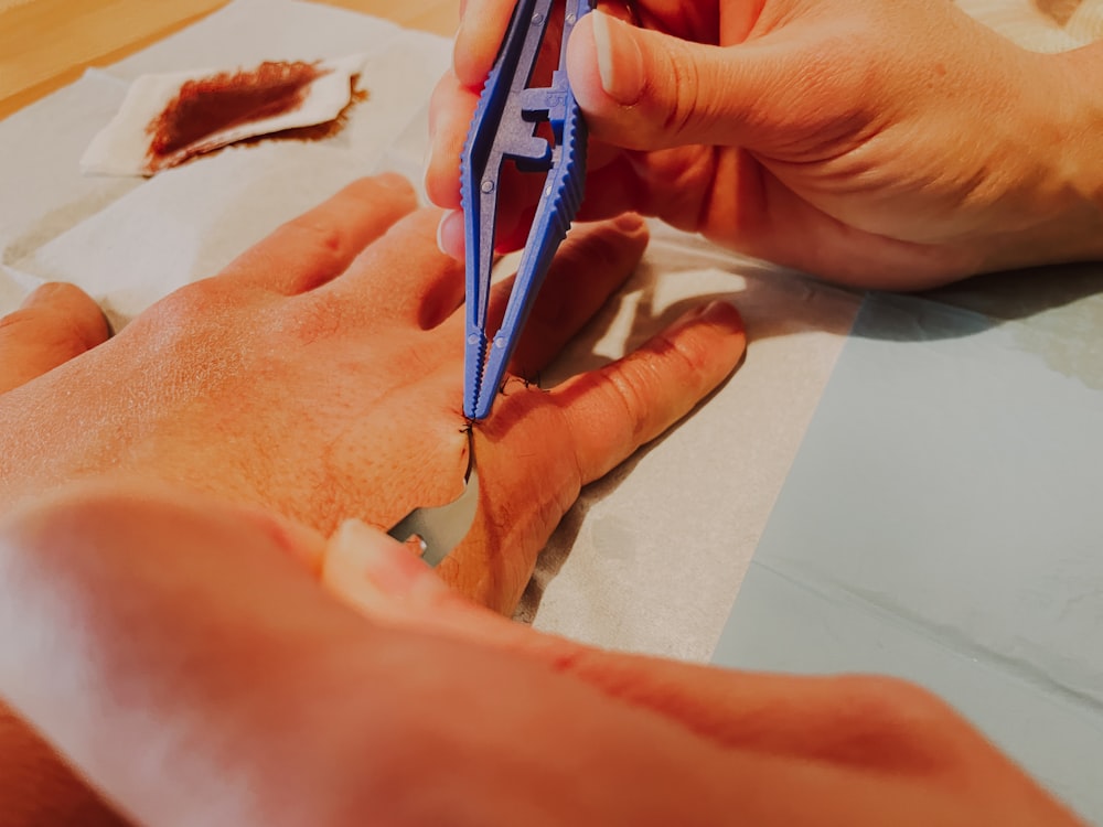 a person cutting a piece of paper with a pair of scissors