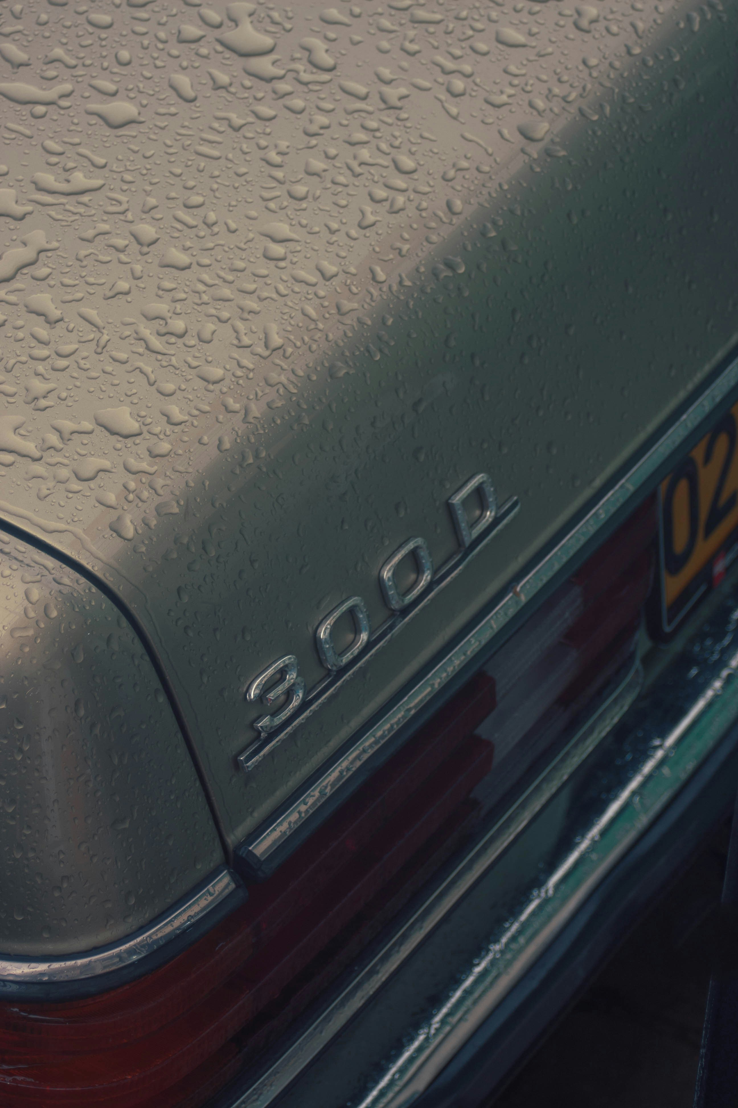 a close up of a car with water droplets on it