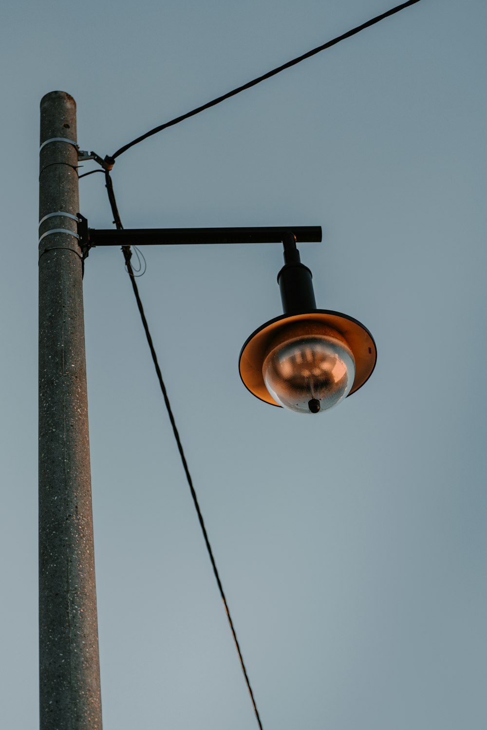 a street light hanging off the side of a pole