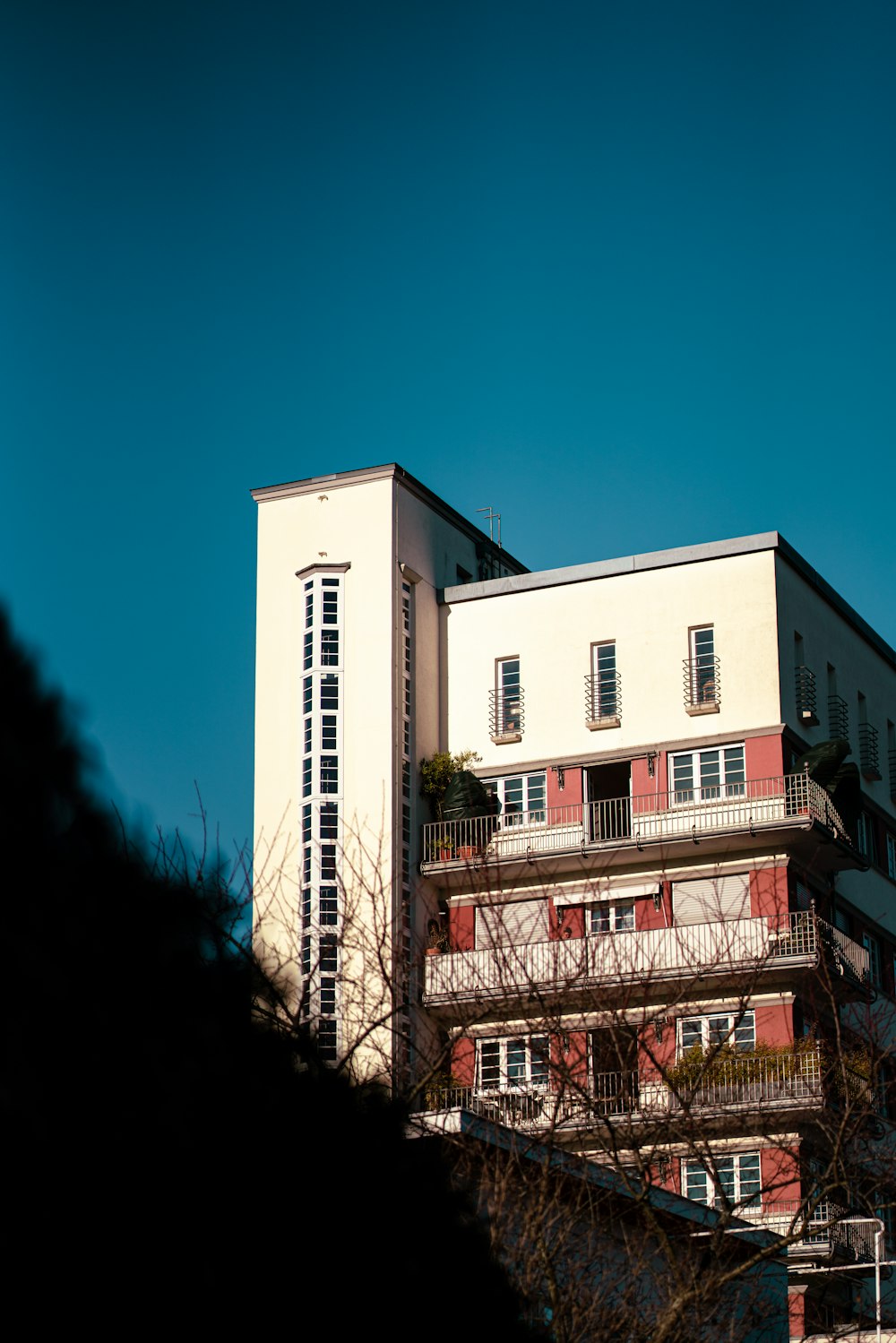 a tall building with balconies on top of it