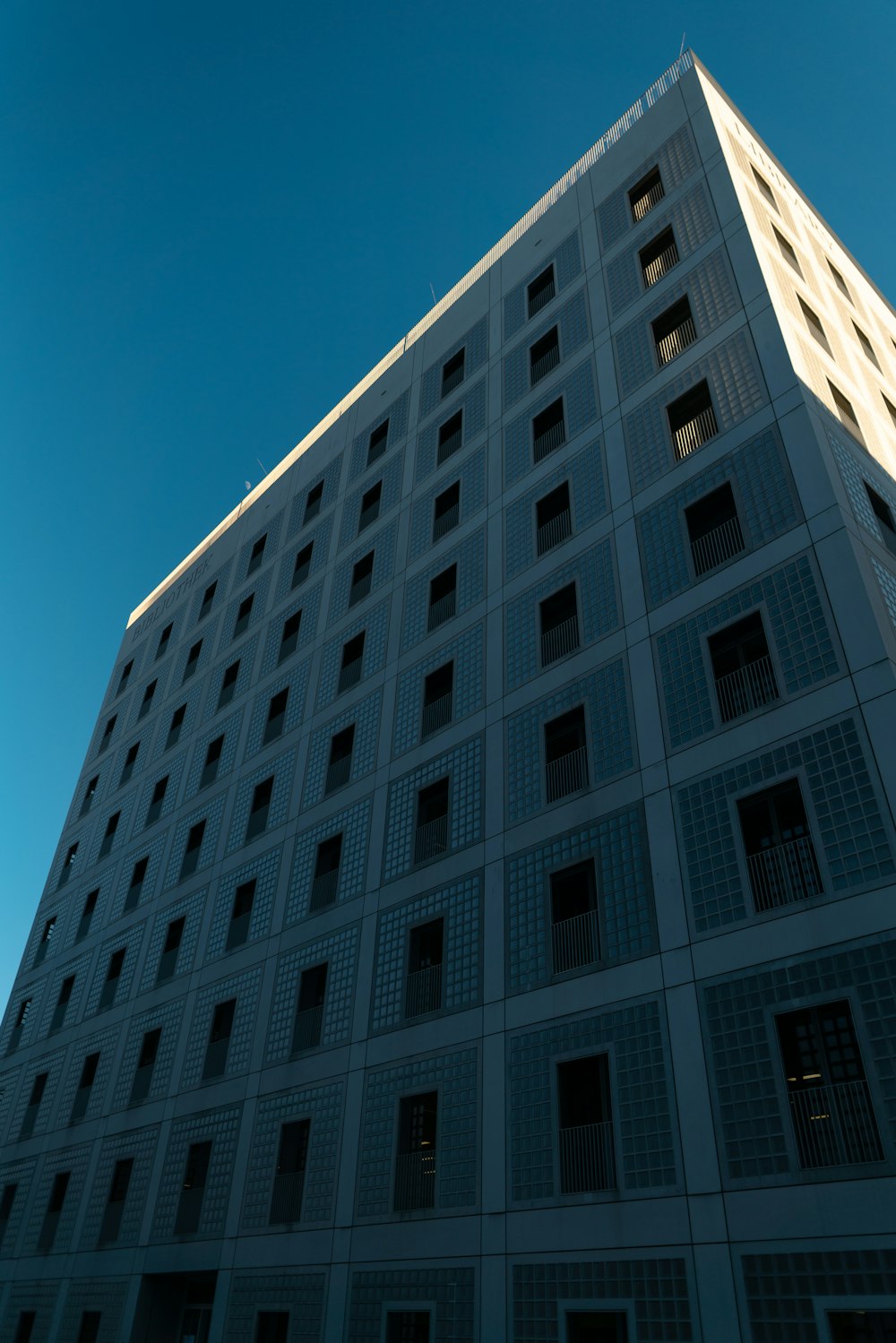 a tall white building with lots of windows