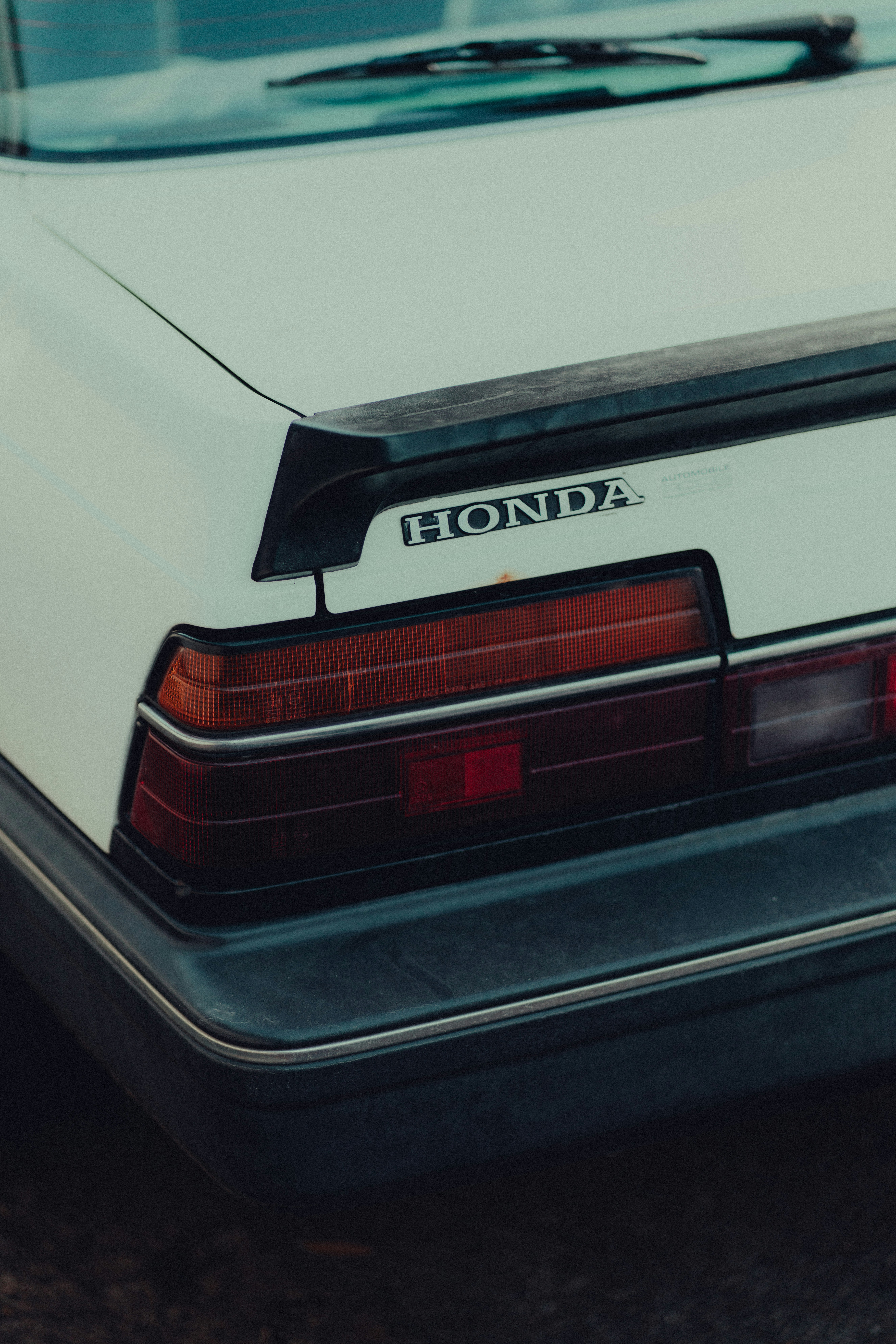 a white honda car parked in a parking lot