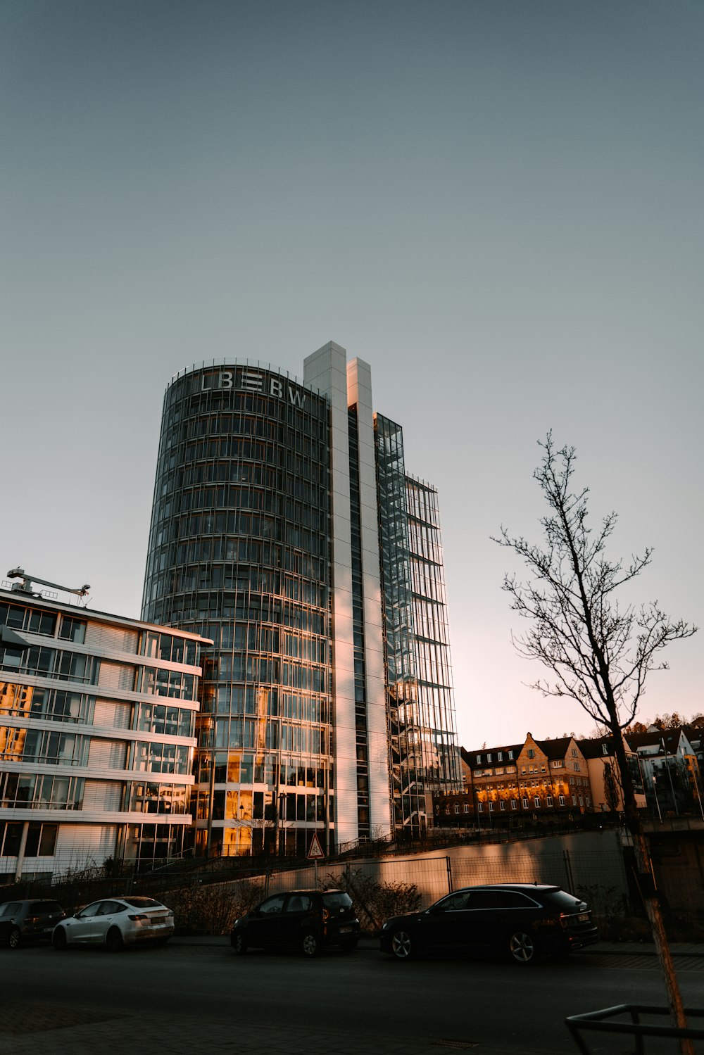 a tall building sitting next to a parking lot