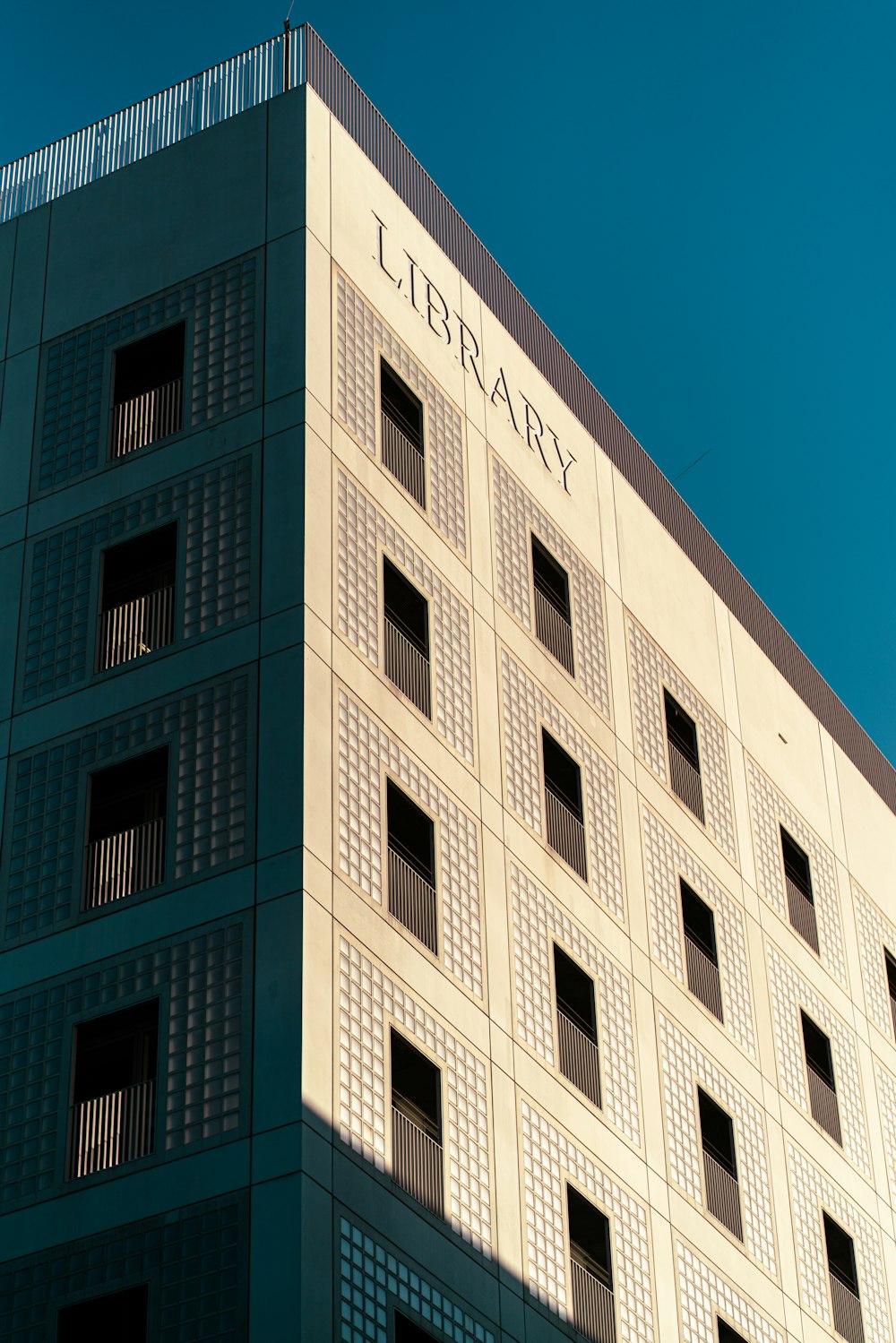 a tall building with a library sign on it's side